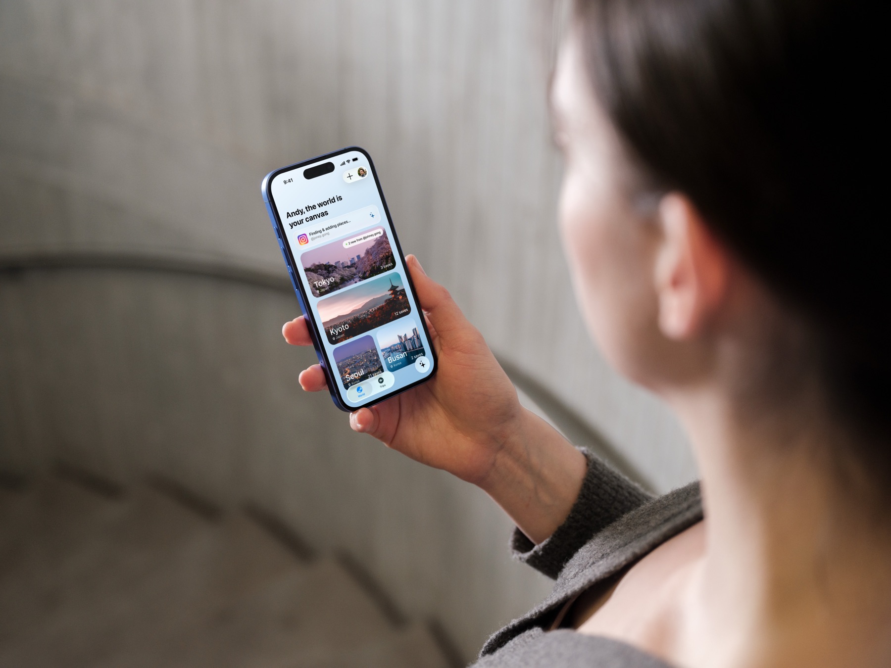 Woman holding iPhone showing Paper Plane